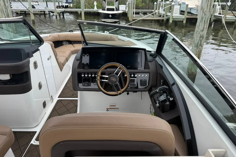 Slide: The Image of 2020 Cobalt 30SC boat interior with steering wheel and control panel at dock. - 15