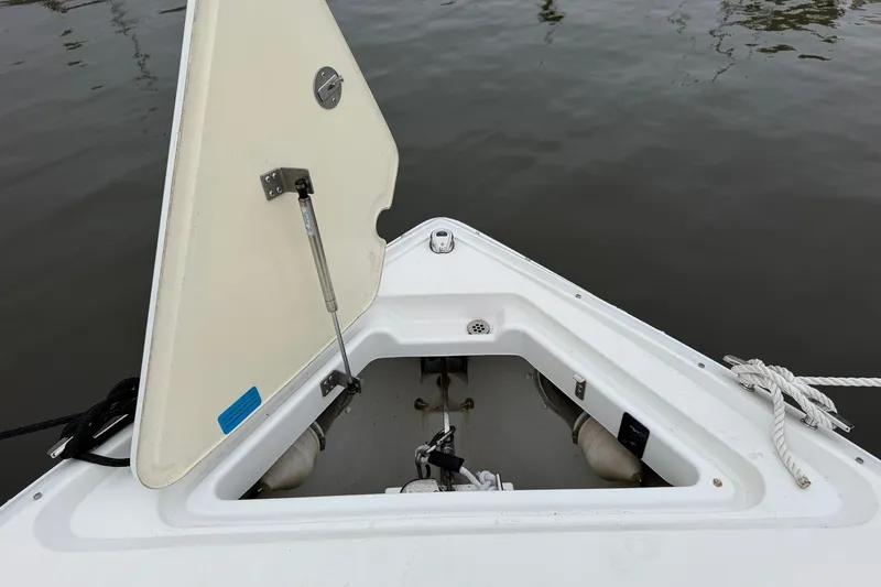 Slide: The Image of Open hatch on 2020 Cobalt 30SC boat, showing storage compartment by the water. - 10