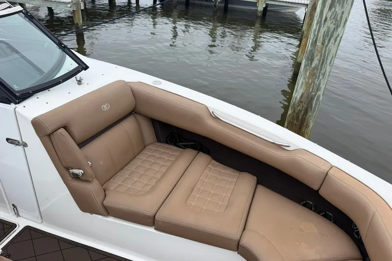 Slide: The Image of Luxurious seating on a 2020 Cobalt 30SC boat docked by the water. - 6