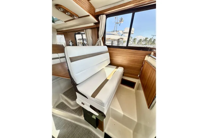 Slide: The Image of Interior of 2026 Ranger Tugs R-31 CB with white seating and wood accents. - 18