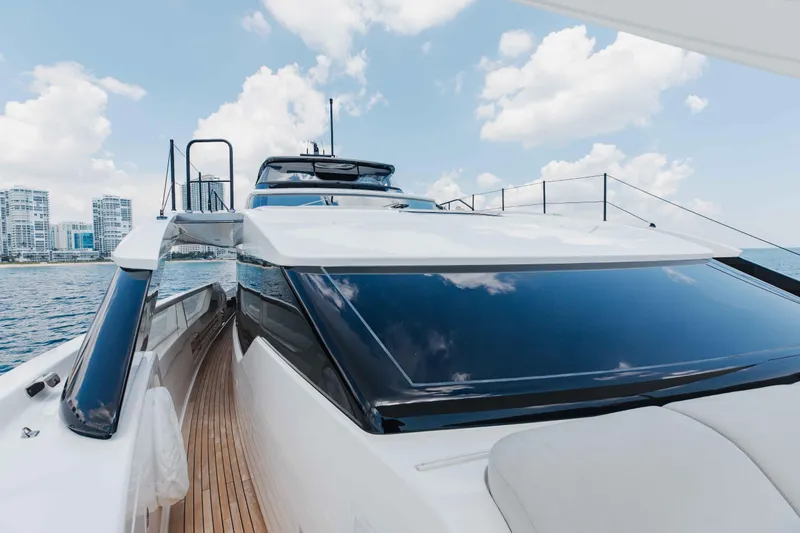 Slide: The Image of 2024 Sanlorenzo SL90A yacht with sleek design, docked near city skyline. - 84