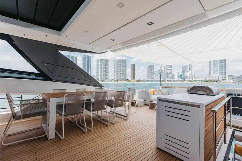 Slide: The Image of Luxurious 2024 Sanlorenzo SL90A yacht deck with modern dining area and city skyline view. - 74