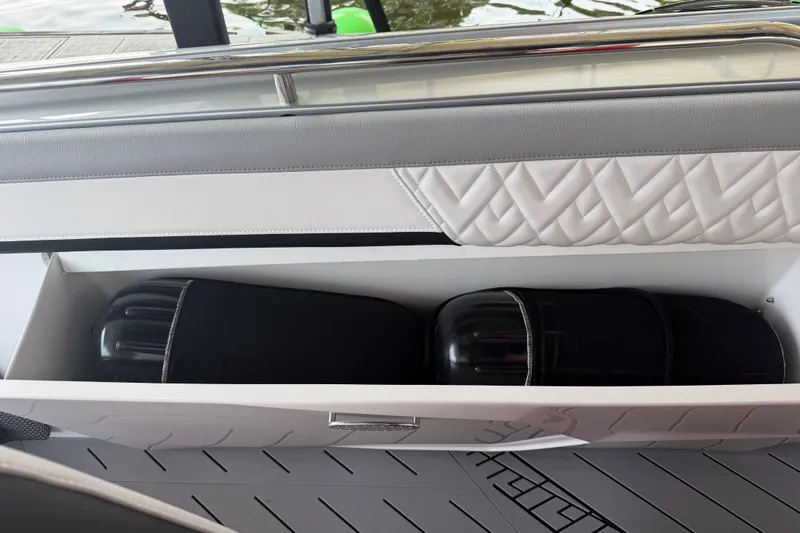Slide: The Image of Storage compartment on 2027 Nor-Tech 42 Eleven boat with black fenders inside. - 43