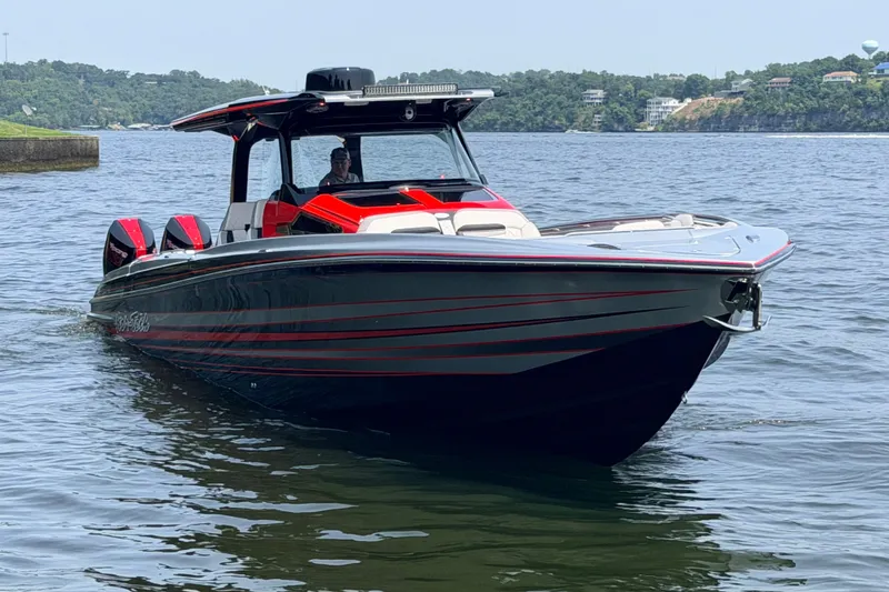 Slide: The Image of 2027 Nor-Tech 42 Eleven boat on water, featuring sleek design and vibrant red accents. - 5