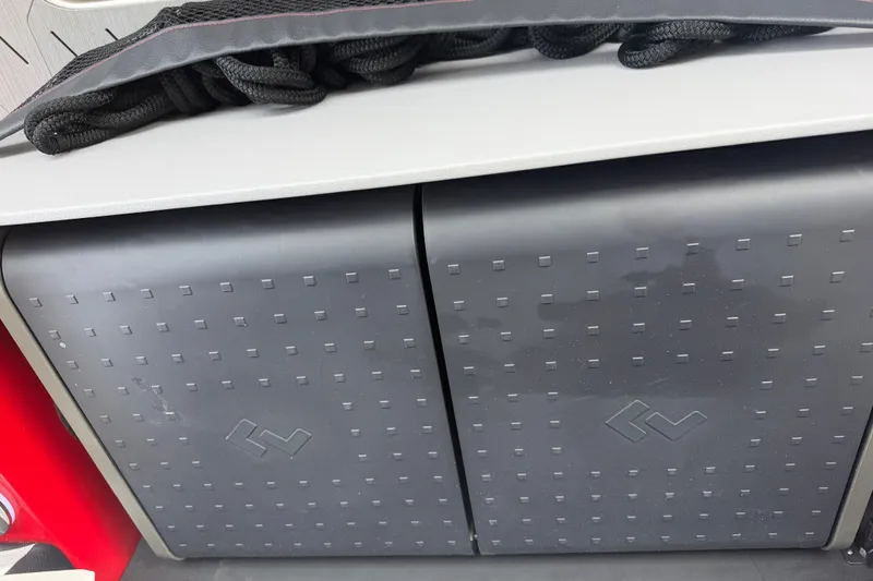 Slide: The Image of Storage compartment on a 2027 Nor-Tech 42 Eleven boat with textured doors and coiled rope. - 40