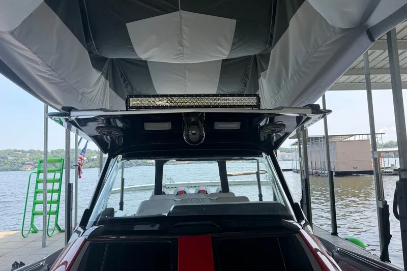 Slide: The Image of Nor-Tech 42 Eleven 2027 boat docked under canopy at marina. - 63