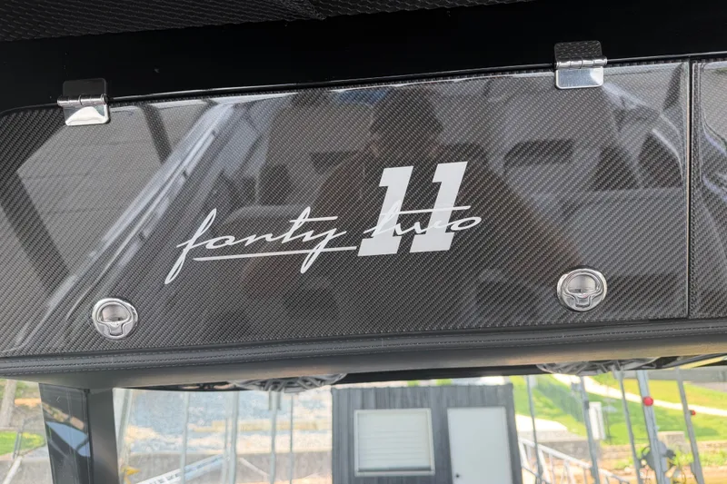 Slide: The Image of 2027 Nor-Tech 42 Eleven boat with carbon fiber detailing and "forty two" branding. - 56