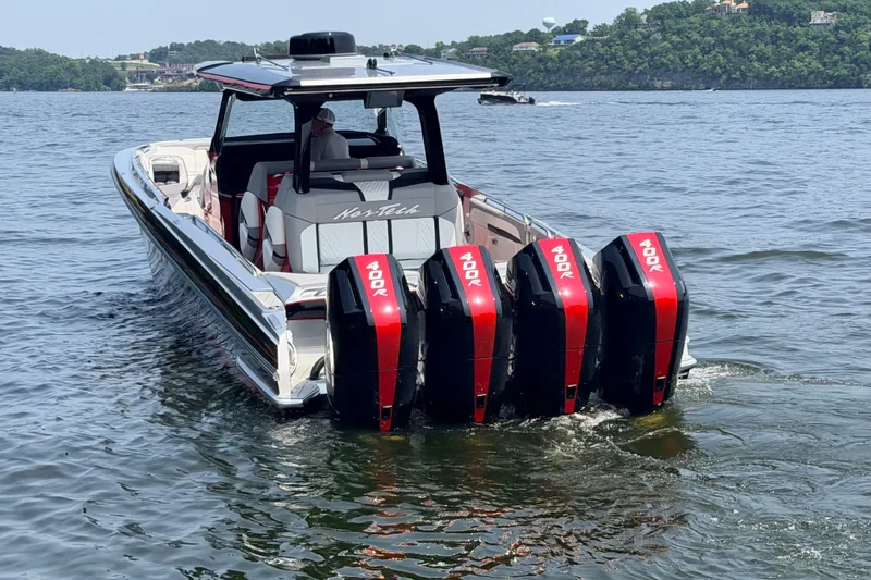 Slide: The Image of Nor-Tech 42 Eleven 2027 boat with four powerful outboard engines on a lake. - 27