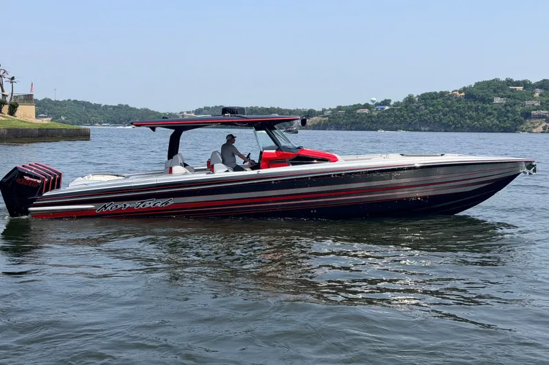 Slide: The Image of 2027 Nor-Tech 42 Eleven boat on a calm lake with scenic background. - 12