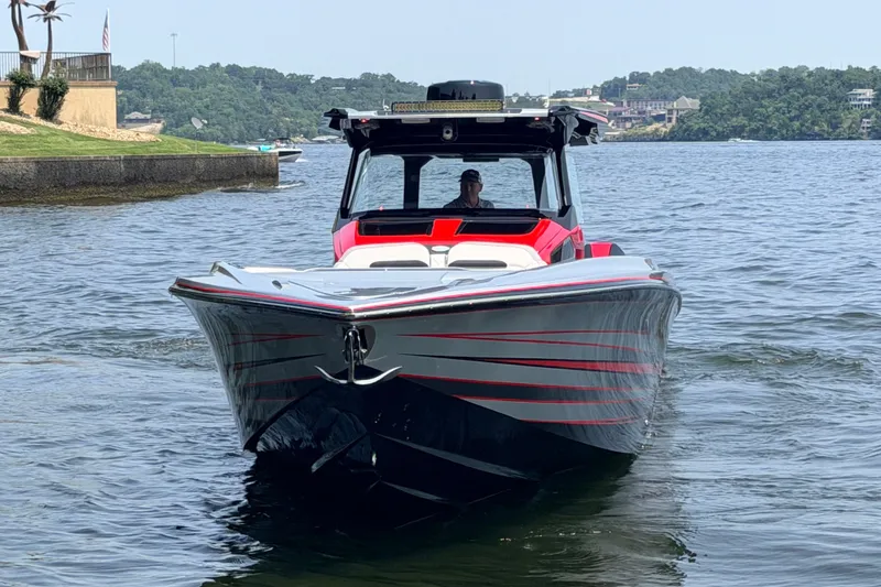 Slide: The Image of Nor-Tech 42 Eleven 2027 boat cruising on a lake with scenic background. - 2