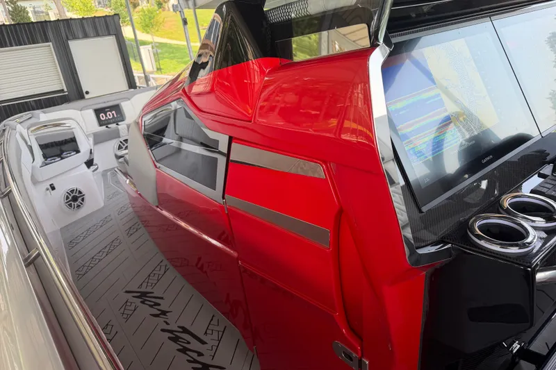 Slide: The Image of 2027 Nor-Tech 42 Eleven boat interior with sleek red design and advanced navigation display. - 54