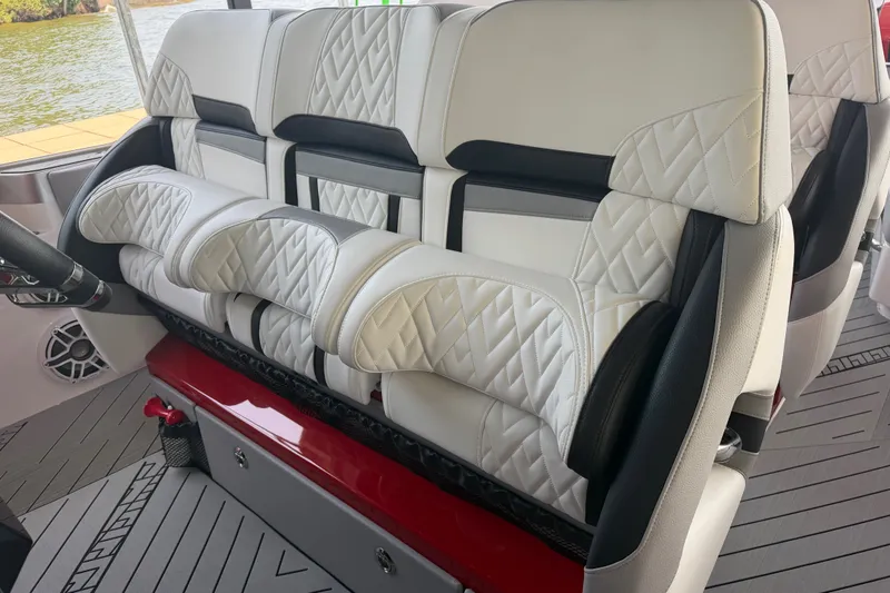 Slide: The Image of Luxurious seating in the 2027 Nor-Tech 42 Eleven boat, featuring quilted white upholstery. - 48