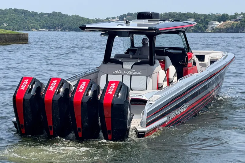 Slide: The Image of Nor-Tech 42 Eleven 2027 boat with quad 400R engines on a scenic lake. - 17