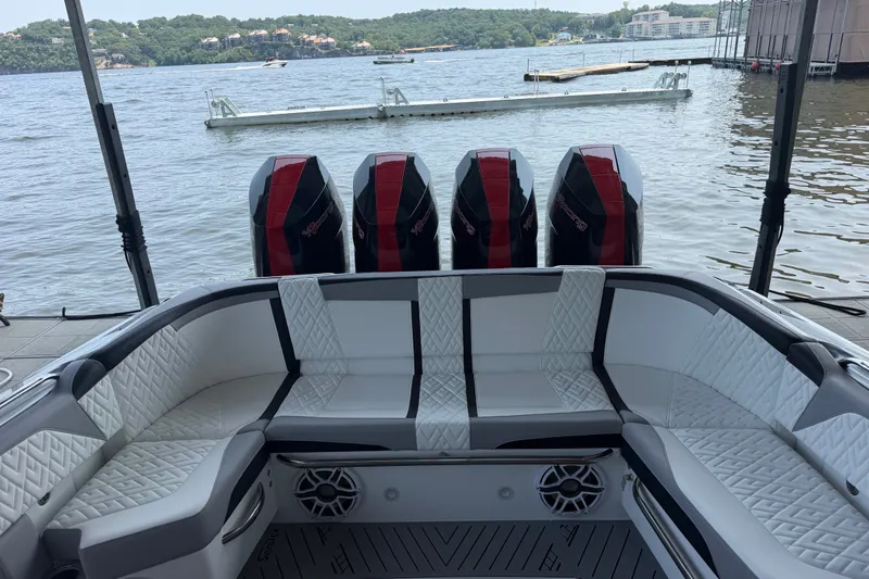 Slide: The Image of 2027 Nor-Tech 42 Eleven boat with luxurious seating and powerful engines docked by the lake. - 37
