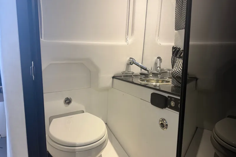 Slide: The Image of Luxurious bathroom interior of 2027 Nor-Tech 42 Eleven boat, featuring modern sink and toilet. - 70