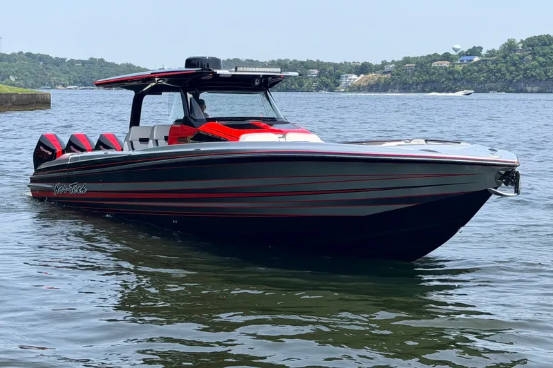 Slide: The Image of 2027 Nor-Tech 42 Eleven boat on water, sleek design with red accents. - 6
