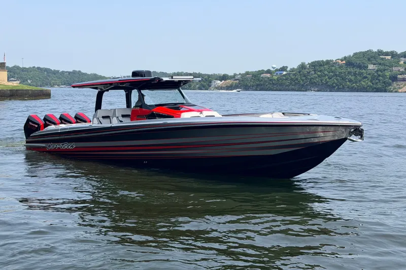 Slide: The Image of 2027 Nor-Tech 42 Eleven boat with sleek design on a calm lake. - 18