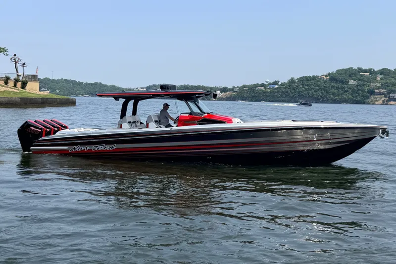 Slide: The Image of Nor-Tech 42 Eleven 2027 boat on a lake, featuring sleek design and powerful engines. - 15