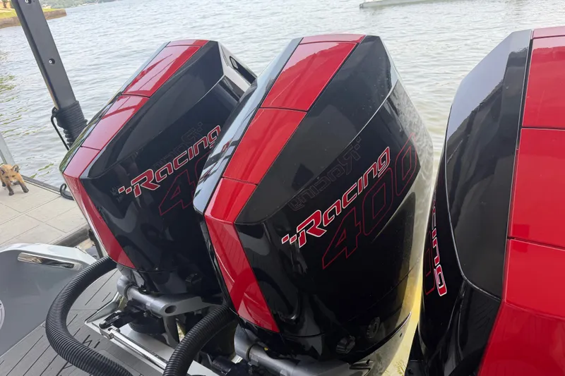 Slide: The Image of Twin Mercury Racing 400 outboard engines on a 2027 Nor-Tech 42 Eleven boat by the water. - 35