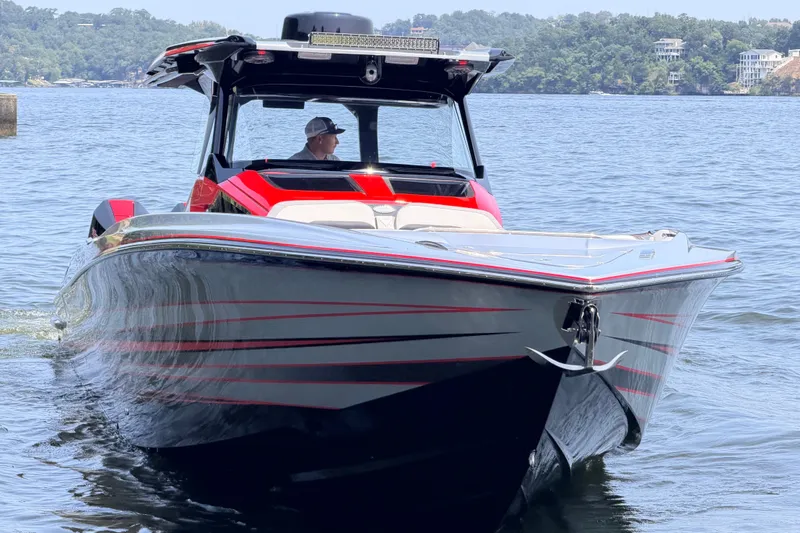 Slide: The Image of 2027 Nor-Tech 42 Eleven boat on water, sleek design with red accents. - 4