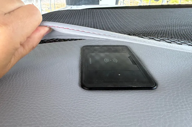 Slide: The Image of Hand lifting seat cushion on 2027 Nor-Tech 42 Eleven, revealing wireless charging pad. - 58
