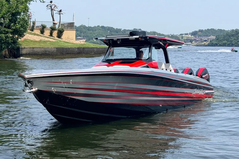 Slide: The Image of 2027 Nor-Tech 42 Eleven boat with sleek red and black design on the water. - 10