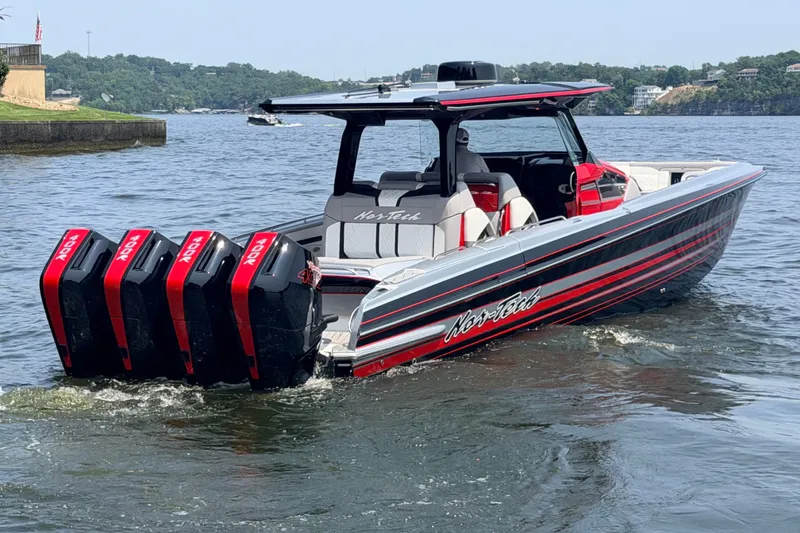 Slide: The Image of 2027 Nor-Tech 42 Eleven boat with quad outboard engines on a lake. - 20