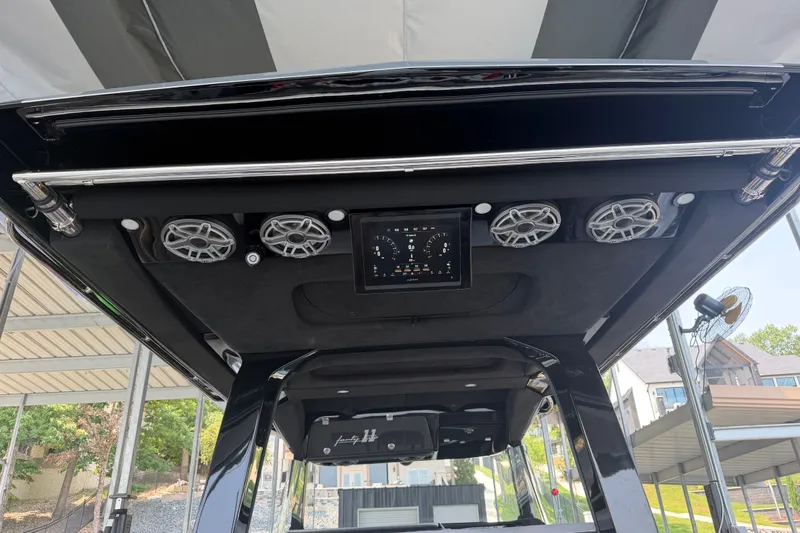 Slide: The Image of Interior view of 2027 Nor-Tech 42 Eleven boat with advanced audio system and digital display. - 38