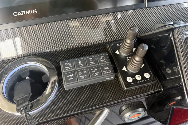 Slide: The Image of Control panel of 2027 Nor-Tech 42 Eleven boat with Garmin display and carbon fiber finish. - 50