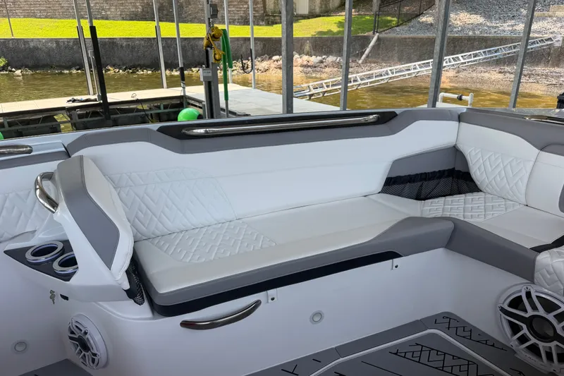 Slide: The Image of Luxurious seating area on a 2027 Nor-Tech 42 Eleven boat, featuring elegant white upholstery. - 64