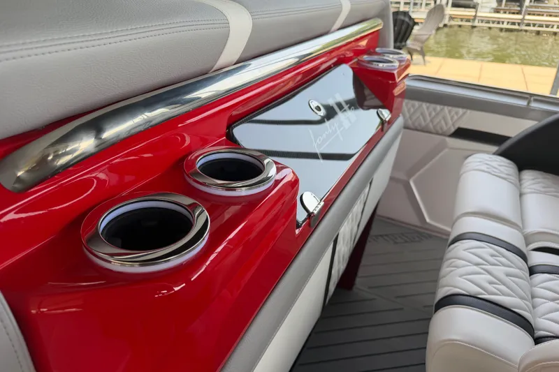 Slide: The Image of Interior of 2027 Nor-Tech 42 Eleven boat with red accents and cup holders. - 46