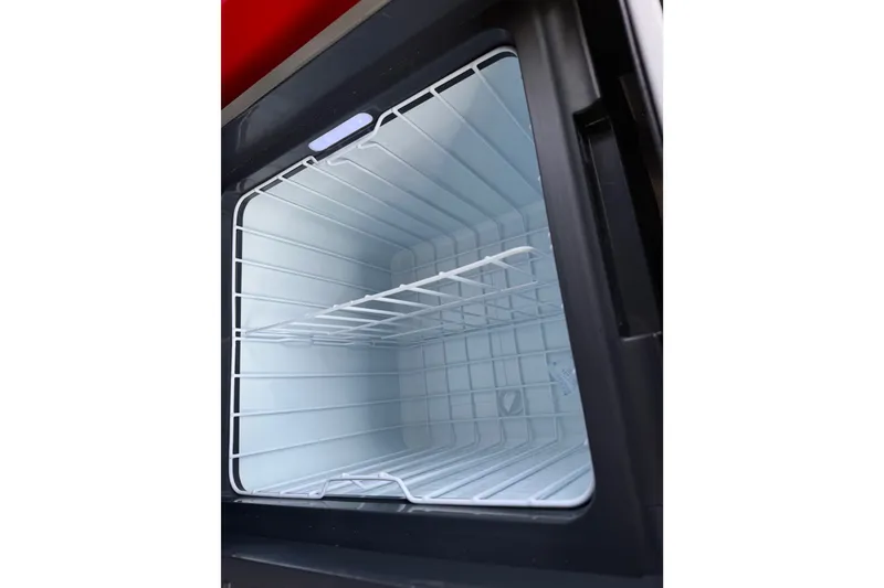 Slide: The Image of Empty refrigerator compartment in a 2027 Nor-Tech 42 Eleven boat. - 41