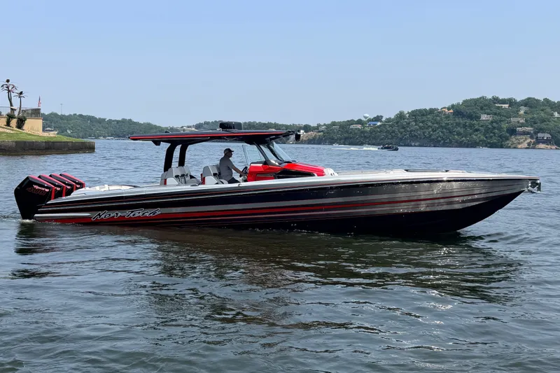 Slide: The Image of Nor-Tech 42 Eleven 2027 boat on a lake, featuring sleek design and powerful engines. - 14