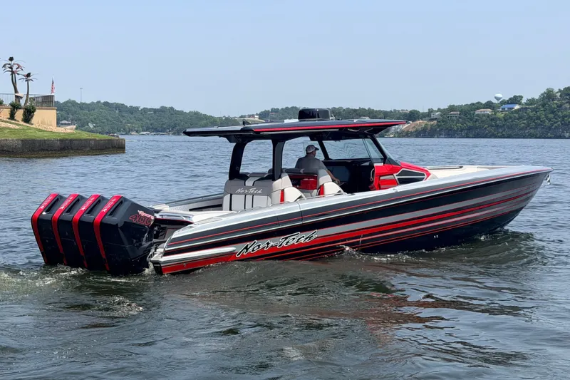 Slide: The Image of 2027 Nor-Tech 42 Eleven boat with quad engines cruising on a lake. - 22