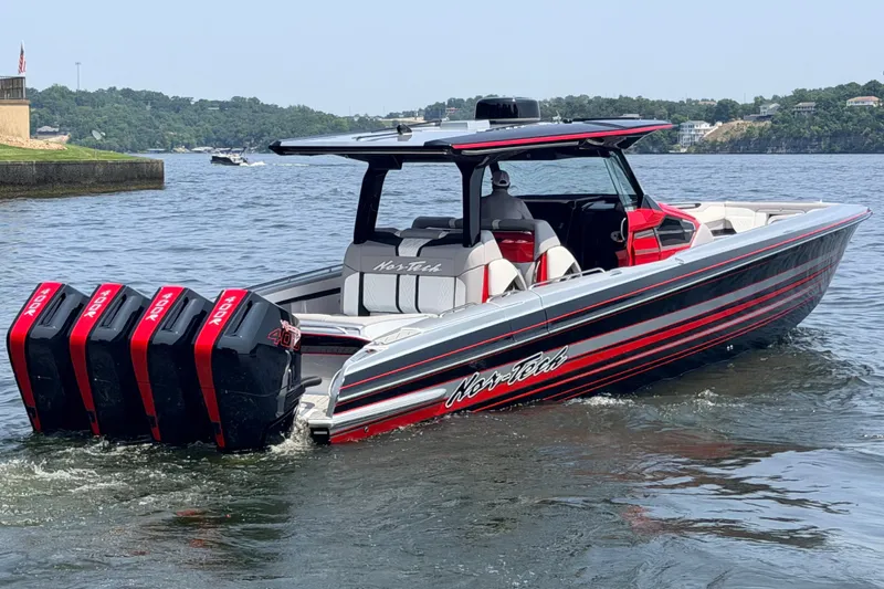 Slide: The Image of 2027 Nor-Tech 42 Eleven boat with quad outboard engines on a scenic lake. - 21