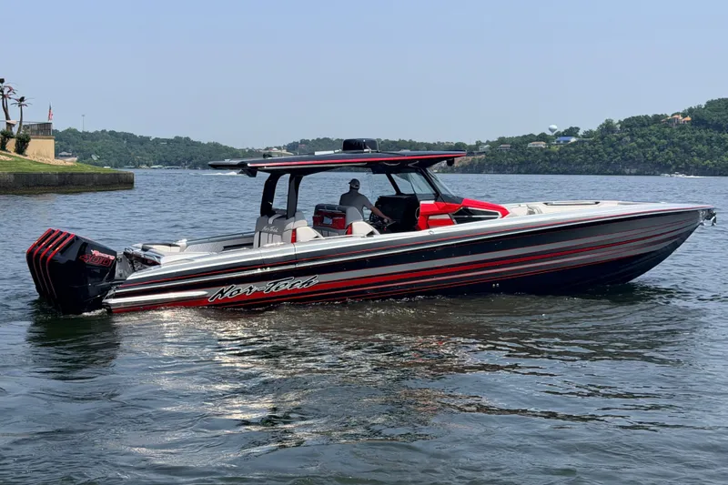 Slide: The Image of 2027 Nor-Tech 42 Eleven boat on a lake, featuring sleek design and powerful engines. - 26