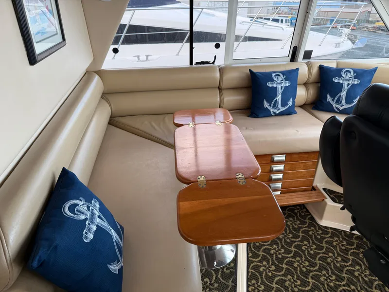 Slide: The Image of Luxurious 2003 Meridian 490 Pilothouse interior with nautical-themed cushions and elegant wood table. - 30