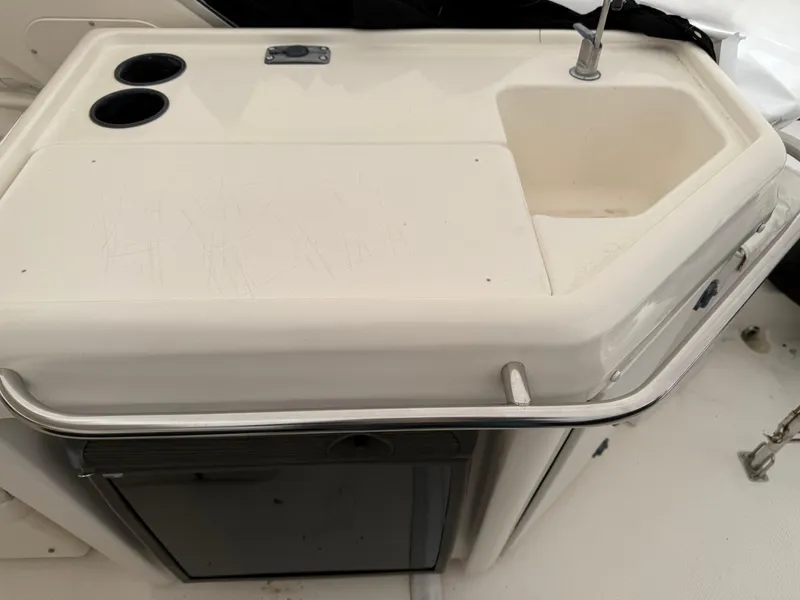 Slide: The Image of 2003 Meridian 490 Pilothouse boat sink and countertop with cup holders. - 48