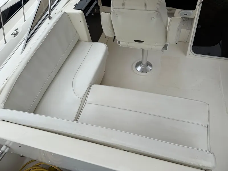 Slide: The Image of 2003 Meridian 490 Pilothouse interior with white seating and captain's chair. - 41