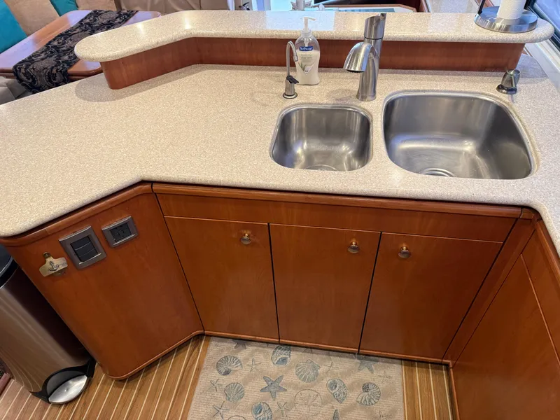Slide: The Image of 2003 Meridian 490 Pilothouse kitchen with dual sinks and wooden cabinetry. - 12