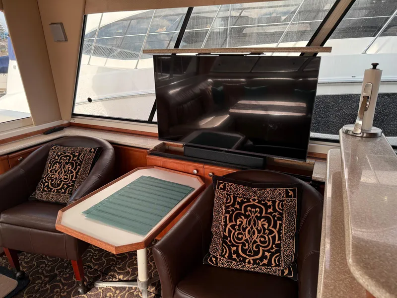 Slide: The Image of Interior of 2003 Meridian 490 Pilothouse with TV, chairs, and decorative pillows. - 8