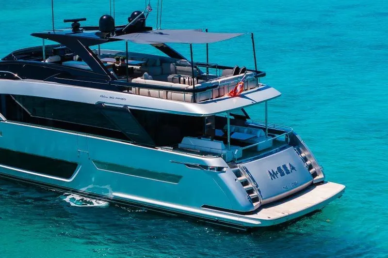 Slide: The Image of Luxury 2022 Riva 90' Argo yacht on turquoise water, rear view. - 43