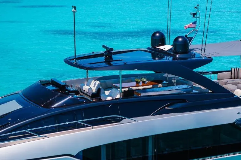 Slide: The Image of Luxurious 2022 Riva 90' Argo yacht on turquoise waters, featuring sleek design and elegant seating. - 44