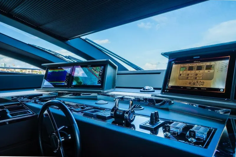 Slide: The Image of Cockpit of 2022 Riva 90' Argo yacht with advanced navigation displays and controls. - 30