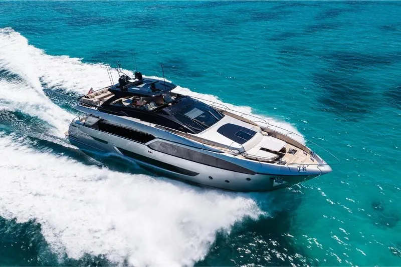 Slide: The Image of Luxurious 2022 Riva 90' Argo yacht cruising on clear turquoise waters. - 4