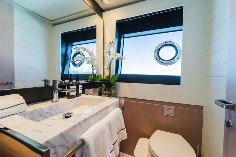 Slide: The Image of Luxurious bathroom on 2022 Riva 90' Argo yacht with marble sink and porthole window. - 25