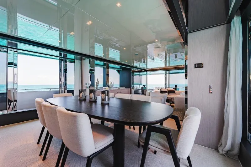 Slide: The Image of Luxurious dining area on a 2022 Riva 90' Argo yacht with ocean views. - 14