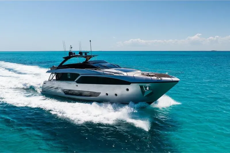 Slide: The Image of Luxury 2022 Riva 90' Argo yacht cruising on turquoise ocean waters. - 5