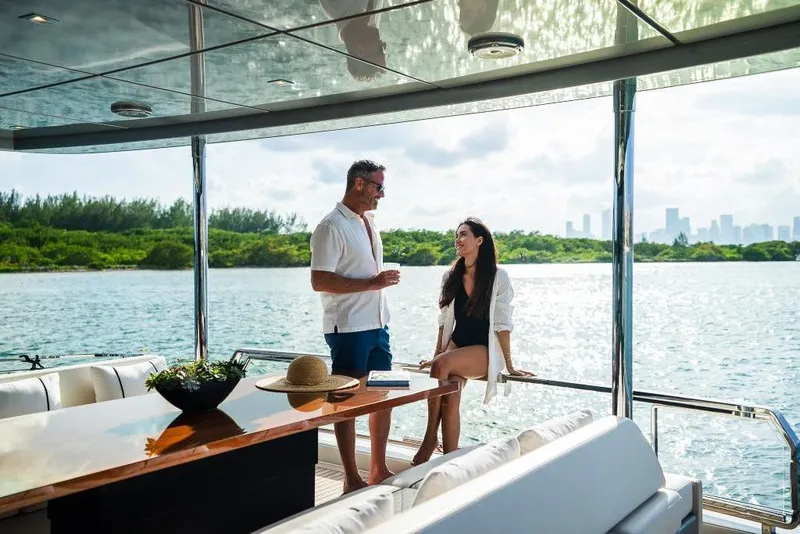Slide: The Image of Couple enjoying a sunny day on a 2022 Riva 90' Argo yacht. - 9