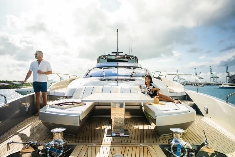 Slide: The Image of Luxury Riva 90' Argo yacht, 2022 model, with people relaxing on deck under a cloudy sky. - 50